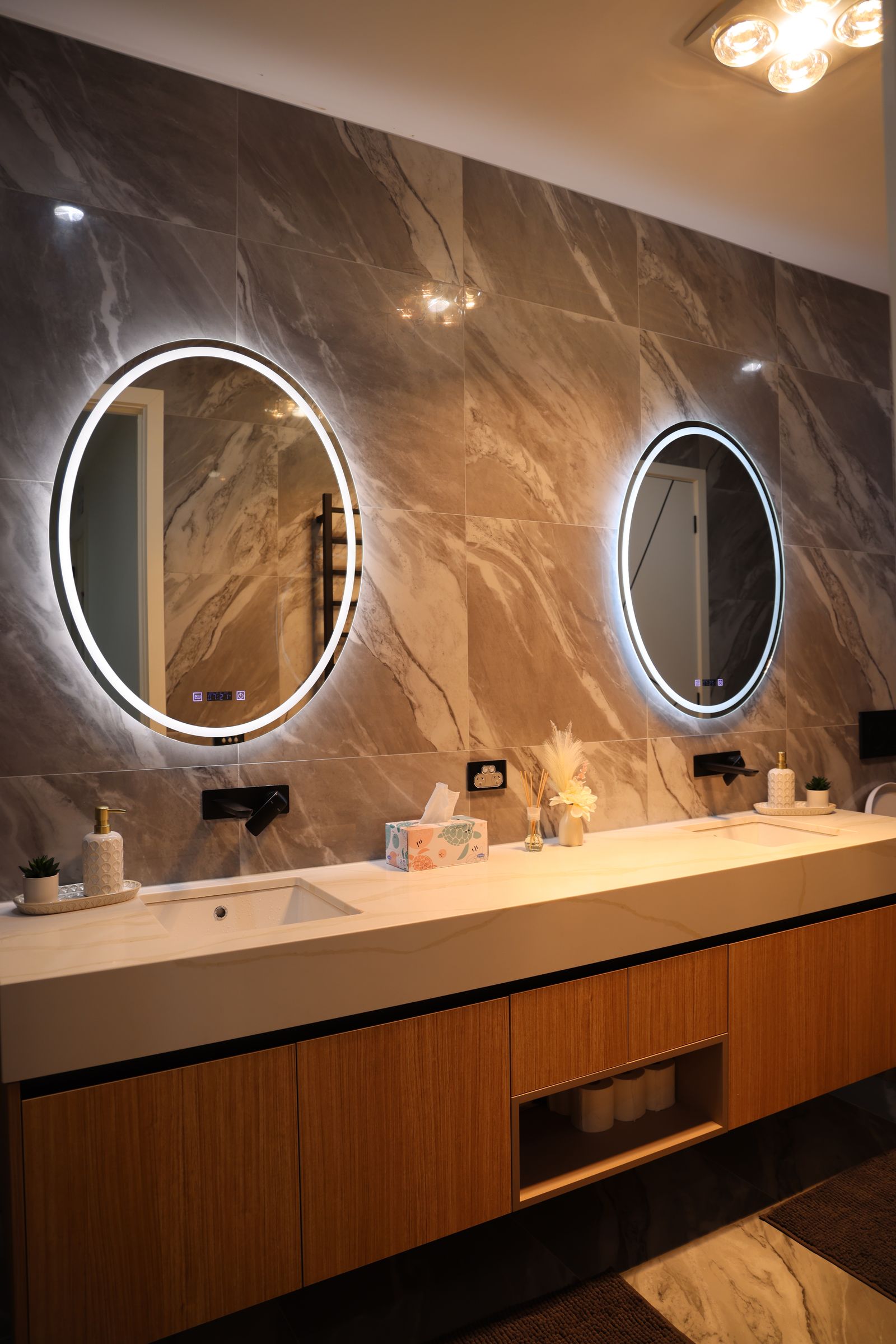 A bathroom vanity with a mirror and soft, warm lighting